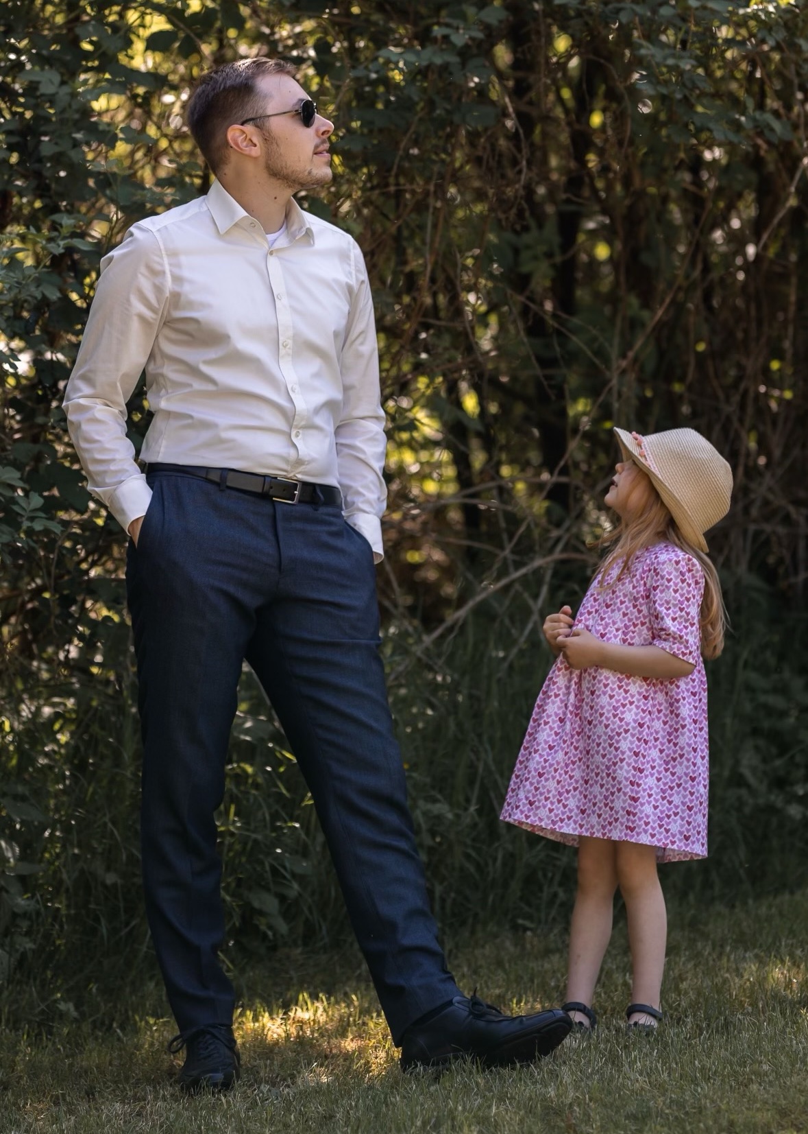 Jacob pondering with a young child on a sunny day.