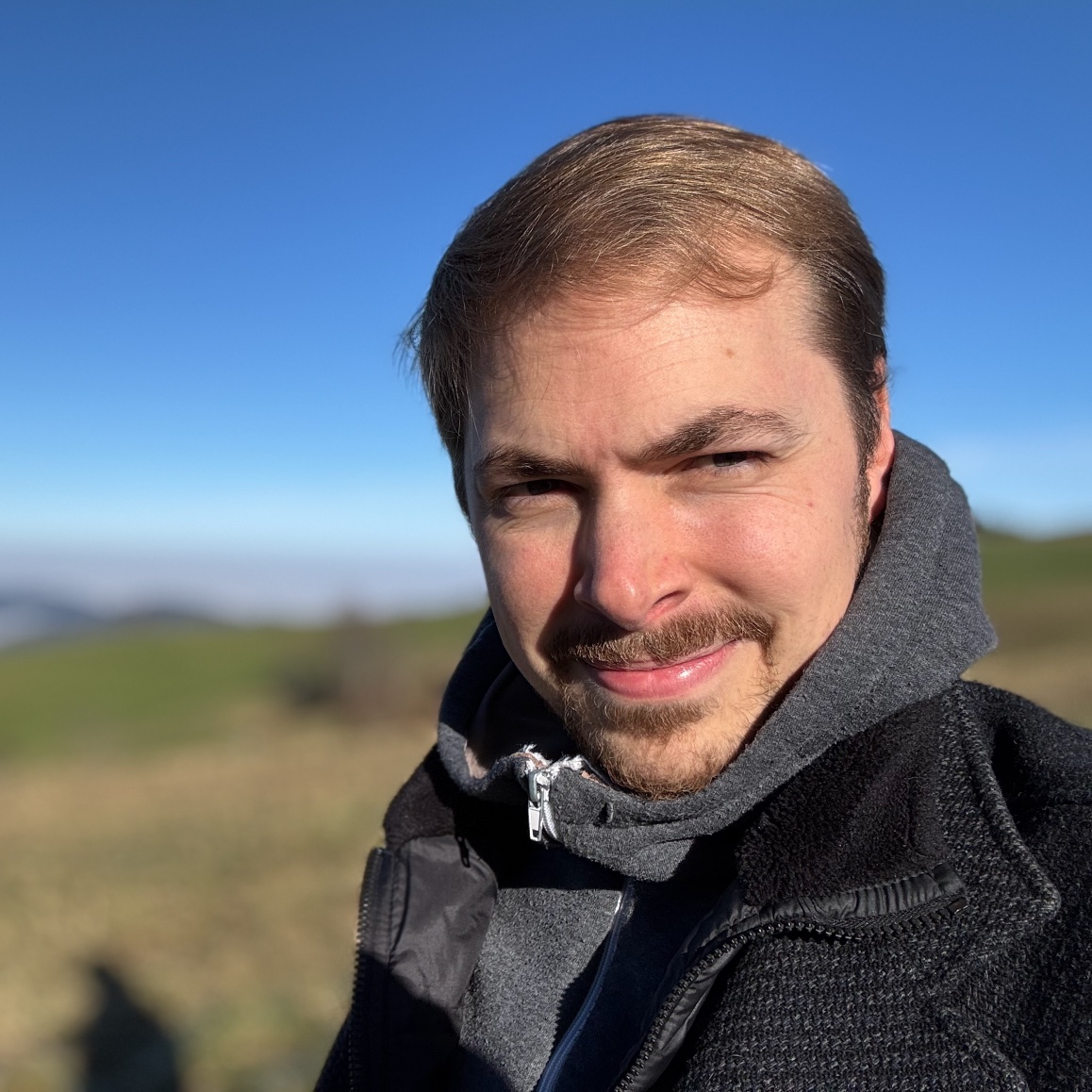 Jacob squinting on a sunny but cold day.